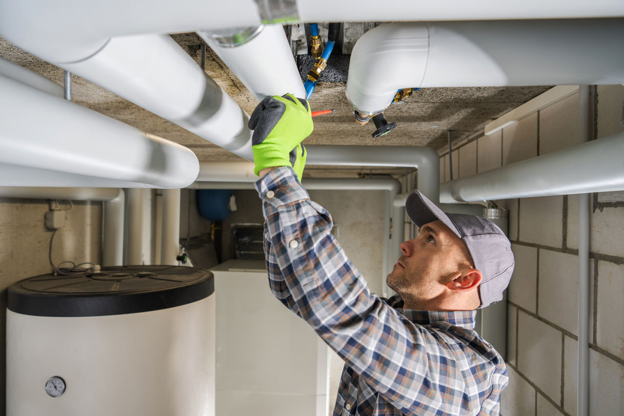 S&W plumber working on pipework and a hot water system