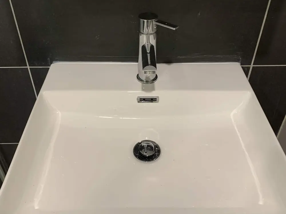 After — a badly cracked bathroom basin replaced with a new basin and mixer tap