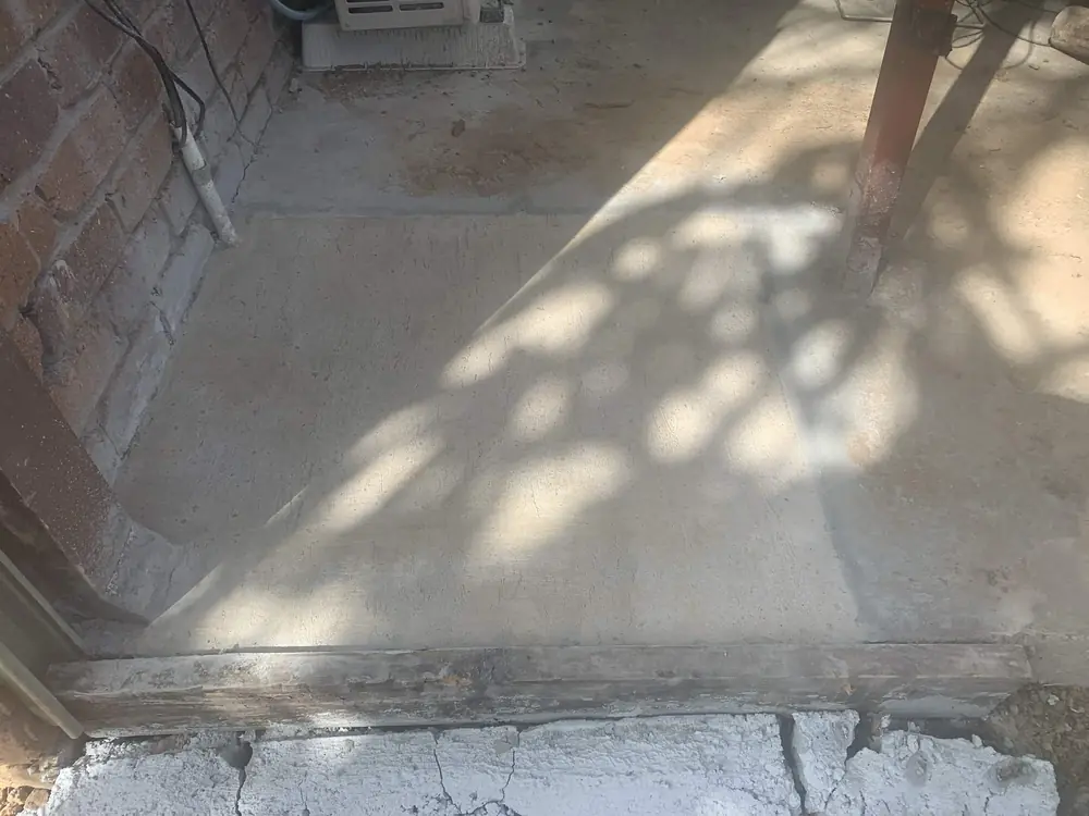 After — reo mesh laid over a drain repair, then the finished concrete poured back level with the existing slab