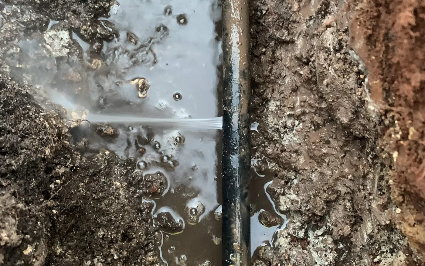 Burst water pipe found and exposed in a trench by S&W Plumbing