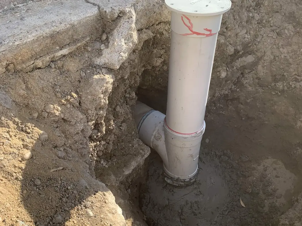 a new sewer inspection opening and riser concreted into place
